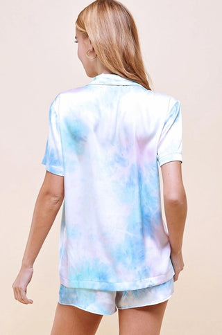 Satin tie dye collared drop shoulder short sleeve pajama set with contrast piping detail on top only. Comes with matching shorts with elastic waistband.