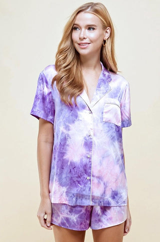 Satin tie dye collared drop shoulder short sleeve pajama set with contrast piping detail on top only. Comes with matching shorts with elastic waistband.