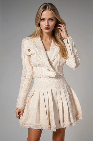 Model wearing beige tweed crop blazer with gold buttons and pleated mini skirt – Brea set by shopUNIQUES