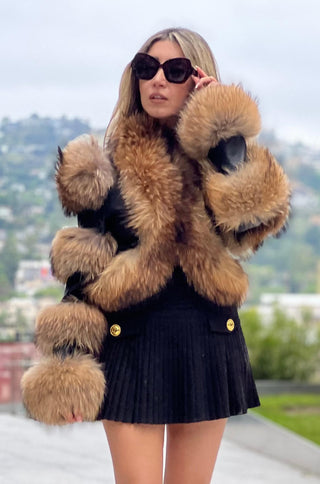 Model wearing matte black lamb leather crop jacket with raccoon fur trim from shopUNIQUES